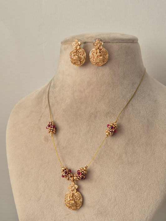Goddess Lakshmi motif choker set with red  kemp stones, intricate Nakshi carvings, and matching earrings by naitri.in