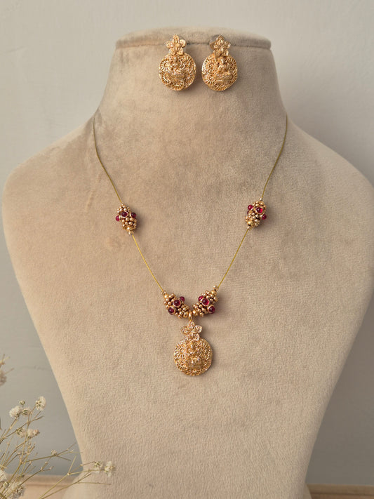 Gold necklace with floral pendants and goddess motifs handcrafted same designed earrings by naitri.in