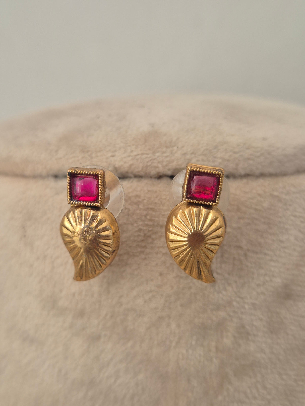 Gold Leaf pattern earrings with with red stone accents by naitri.in
