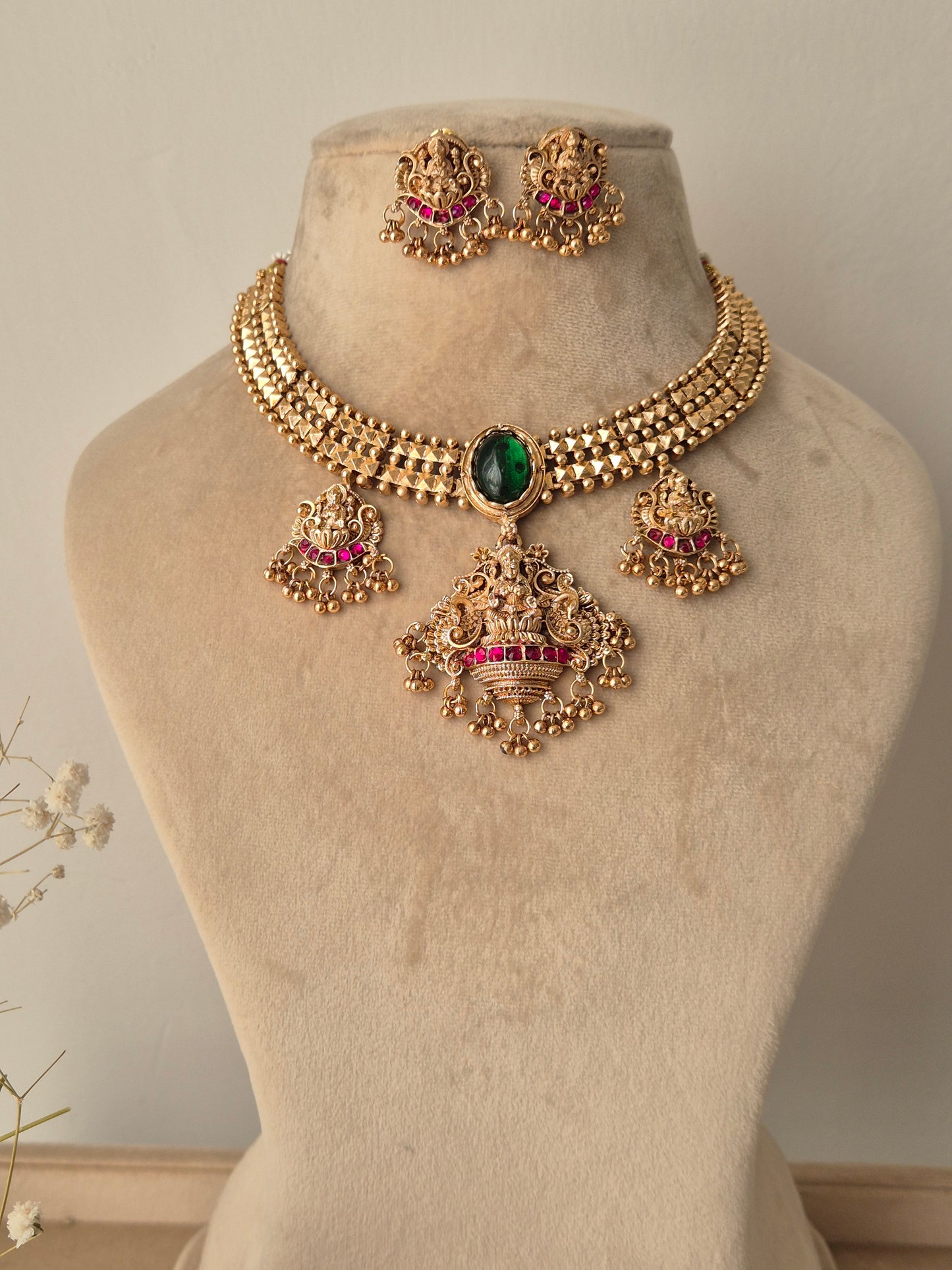 Golden necklace set with goddess motifs with small golden beads hanging with lots of detailings by naitri.in