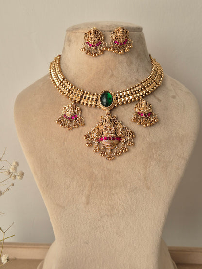 Golden necklace set with goddess motifs with small golden beads hanging with lots of detailings by naitri.in