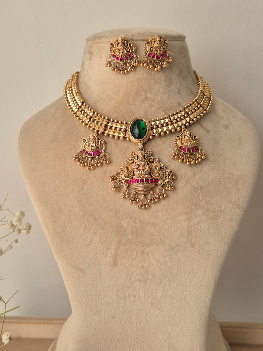 Golden necklace set with goddess motifs with small golden beads hanging with lots of detailings by naitri.in