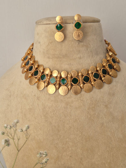 Artisanal  and earring set in a modern Indian aesthetic, Gold-plated brass choker with green stone embellishments, a dangling coin fringe, and coordinating festive stud earrings