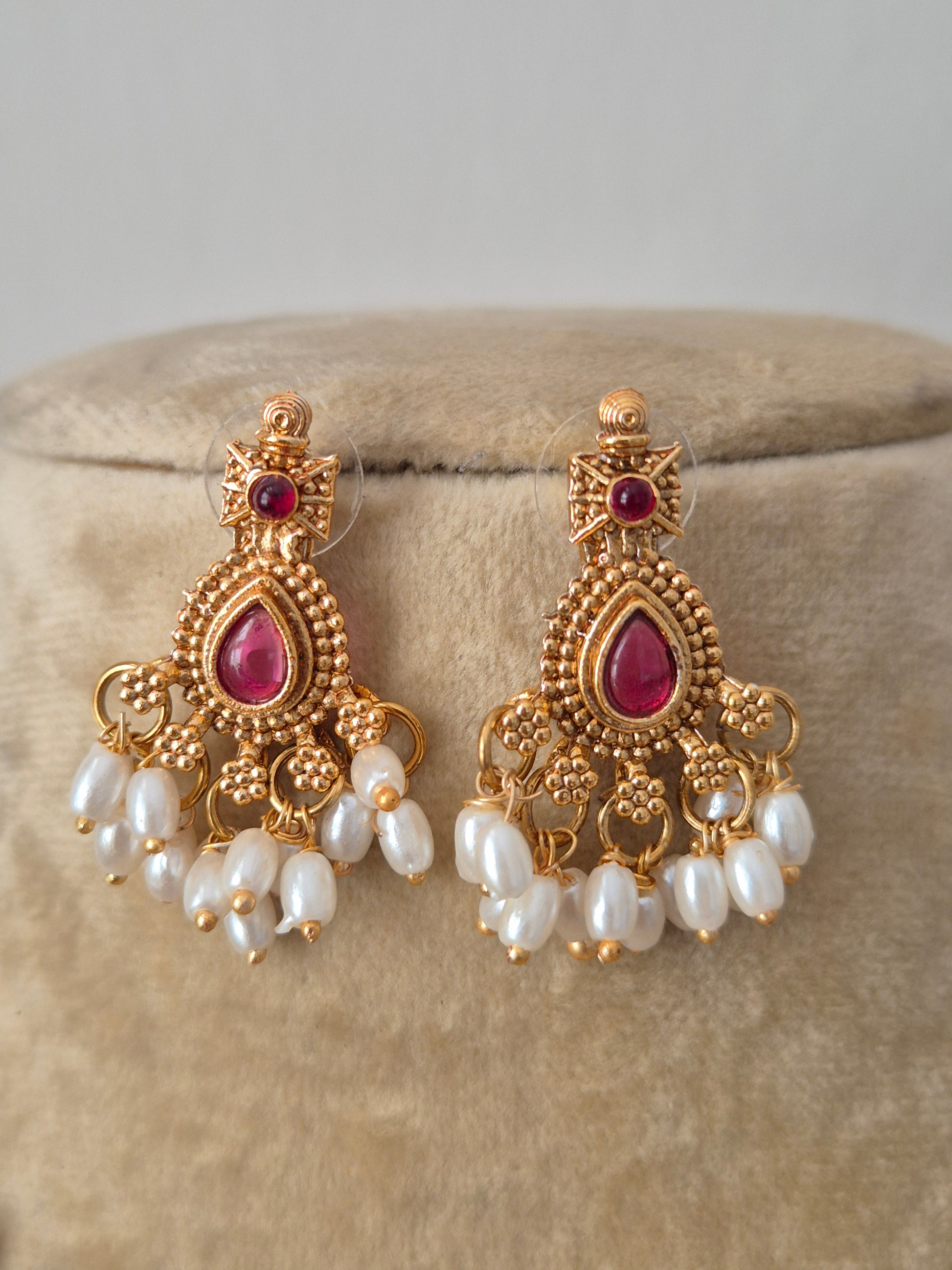 Artisanal Utsha earring in a modern Indian ethnic aesthetic with red stone accents, small dangling pearls earrings by naitri.in