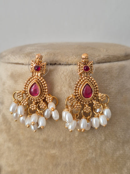 Artisanal Utsha earring in a modern Indian ethnic aesthetic with red stone accents, small dangling pearls earrings by naitri.in