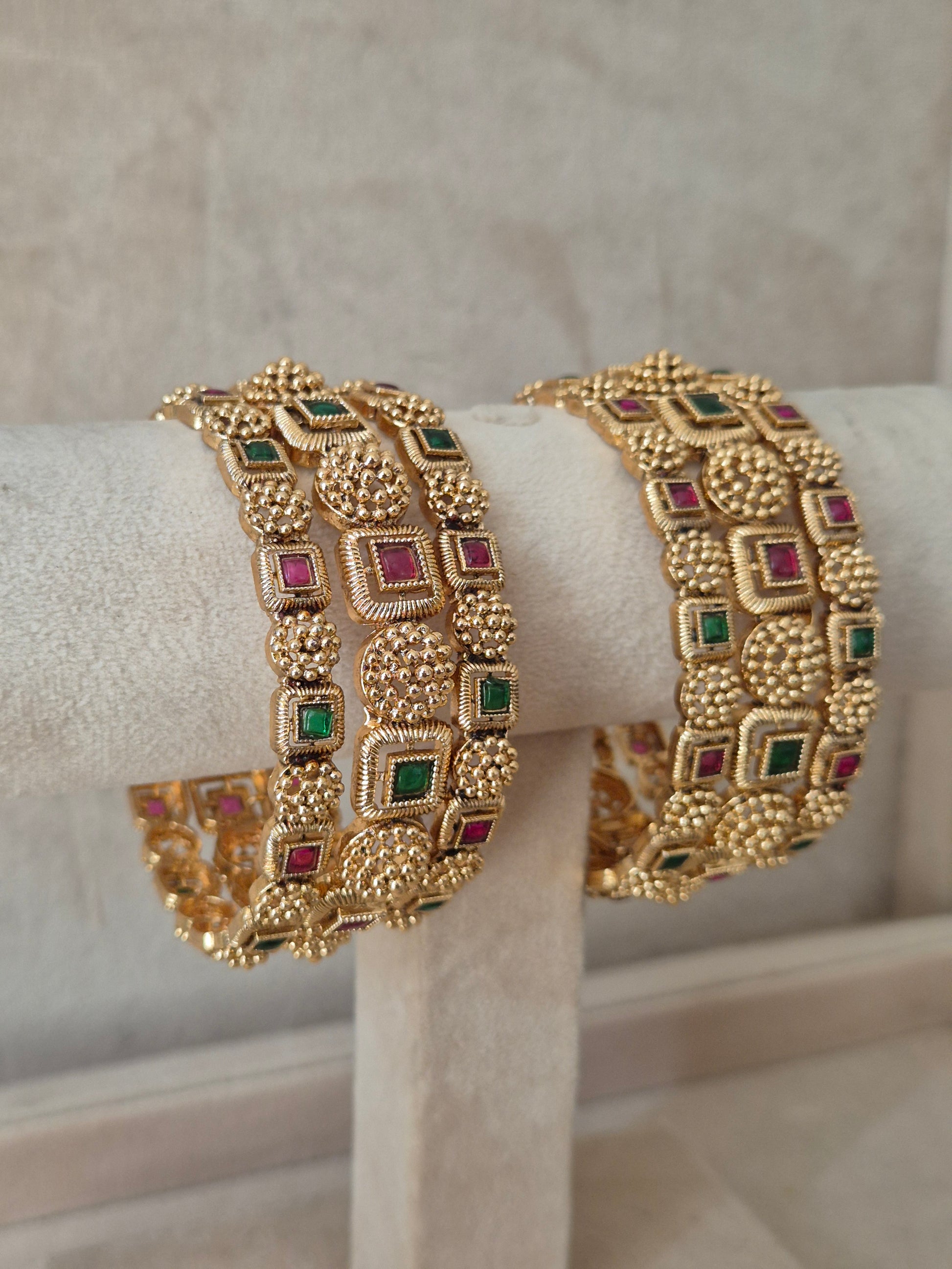 Elegant golden statement bangles with ethnic gemstone by naitri.in