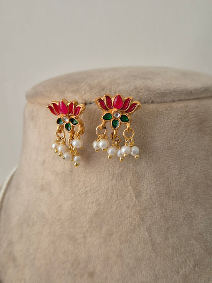 Pair of gold earrings with pink petals and green leaves and white pearls a small stone in the middle minimal and aesthetic design by naitri.in 