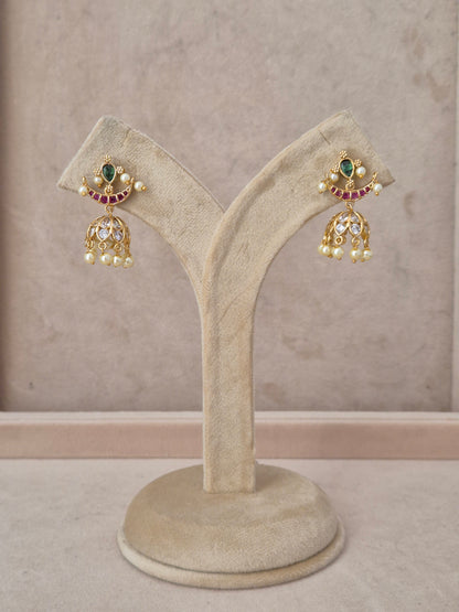 Handcrafted gold-plated Jhumka earrings featuring a crescent moon design with green and ruby-red stones and white pearl by naitri.in