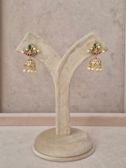 Handcrafted gold-plated Jhumka earrings featuring a crescent moon design with green and ruby-red stones and white pearl by naitri.in