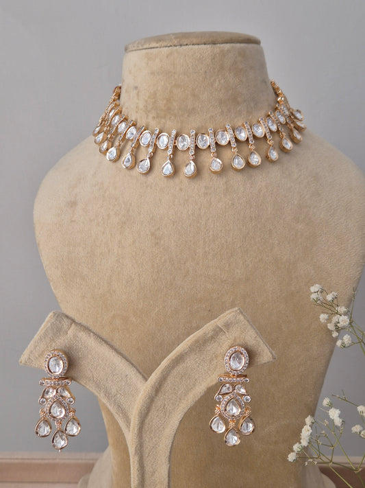 Handcrafted rose-gold plated choker featuring a row of shimmering teardrop-shaped American Diamonds and matching drop earrings by naitri.in