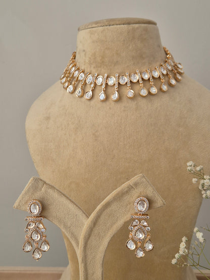 Traditional yet modern Indian Victoria necklace set with dangling American Diamond stones, drop earrings with a floral stud and teardrop crystal, displayed alongside the coordinating stately choker necklace by naitri.in