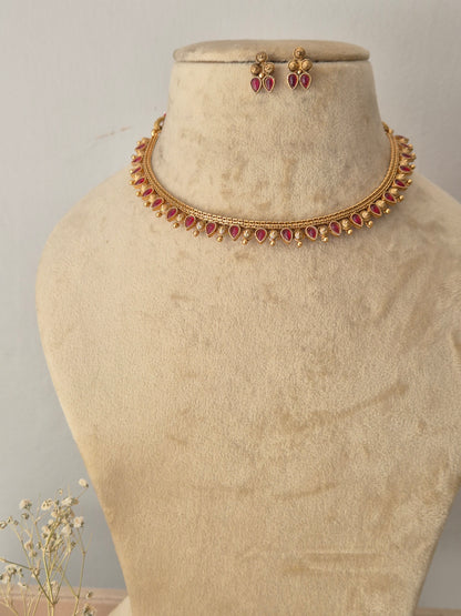 Wardah Necklace Set by Naitri featuring an ethnic gold-plated choker and matching traditional stud earrings with red stones for festive wear by naitri.in