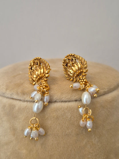 the NAITRI golden earrings, featuring a brass alloy earrings with dangling pearls by naitri.in