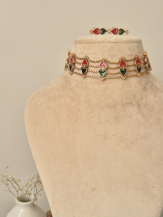 Elegant temple choker set detailed with gold, red, and green tones, shown on a neutral background