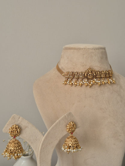 Distinctive temple necklace set blending bronze and gold tones, photographed to emphasize artisanal details