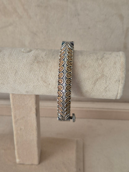 Dual-toned gold and silver Windiya openable bangle with textured geometric blocks. Elegant dual-tone ethnic cuff bracelet with traditional Indian detail by naitri.in