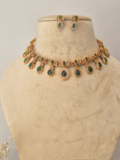 Necklace Set by Naitri featuring an ethnic gold-plated choker and matching traditional drop earrings with green teardrop stones for festive wear by naitri.in