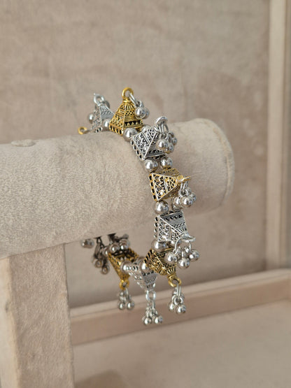 Close-up of Naitri Yachana premium mixed-metal ethnic bracelet showcasing traditional Indian tribal craftsmanship with a vintage, antique finish and hanging bell clusters by naitri.in