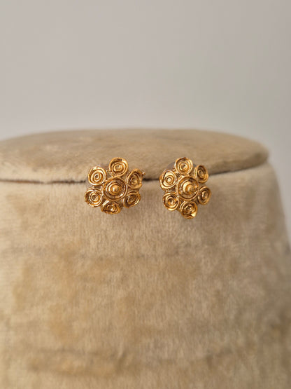 a central gold-toned floral studs by naitri.in
