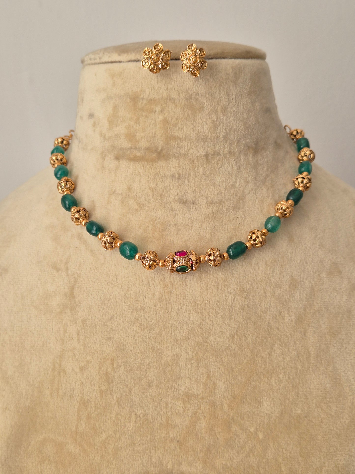 Yamini gold-plated beaded necklace with green gemstone accents and matching stud earrings by naitri.in