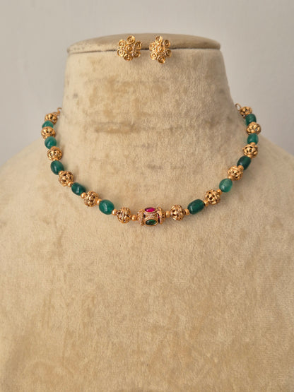 Yamini gold-plated beaded necklace with green gemstone accents and matching stud earrings by naitri.in