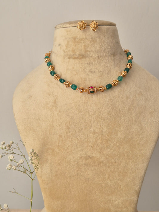 Necklace Set featuring a gold-toned beaded chain with green and red accents and matching ethnic stud earrings by Naitri.in