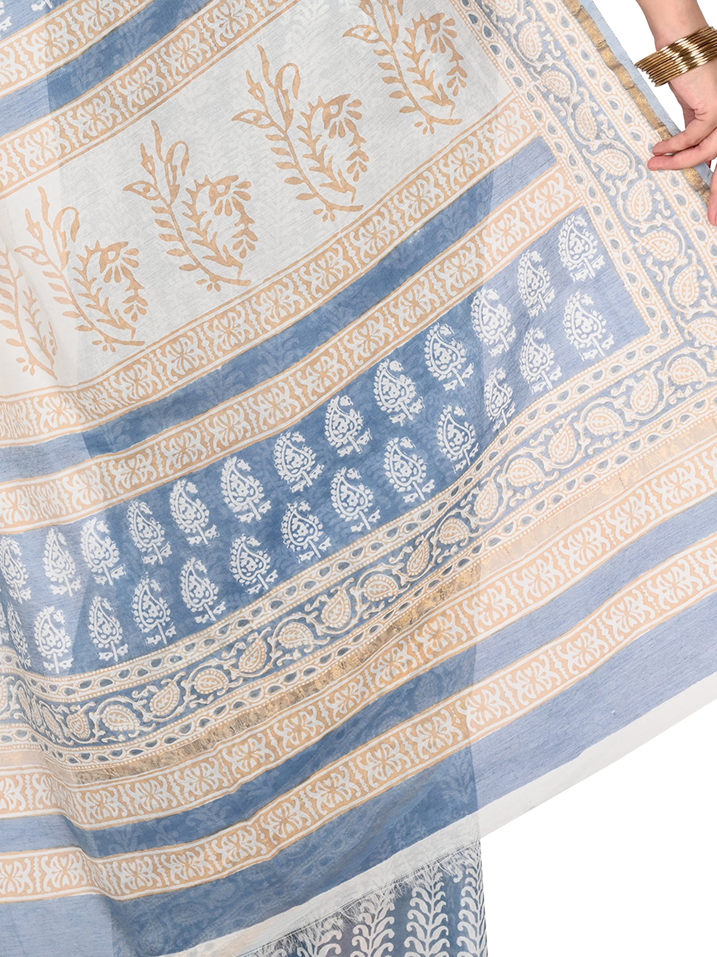 Close-up shot of the soft cotton silk fabric texture and gold border of the blue Zeenia Maheshwari hand-blocked saree by naitri.in