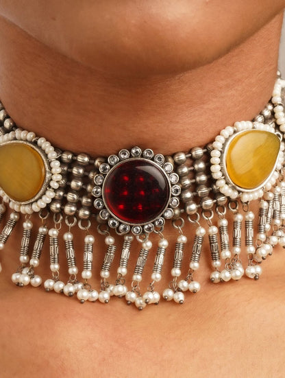 Woman wearing brass Sajini choker necklace and earrings set by Naitri.