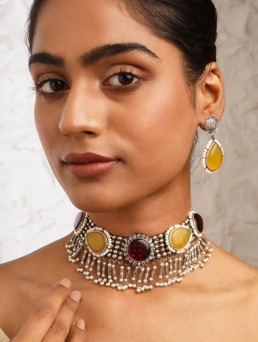 Woman wearing brass Sajini choker necklace and earrings set by Naitri.