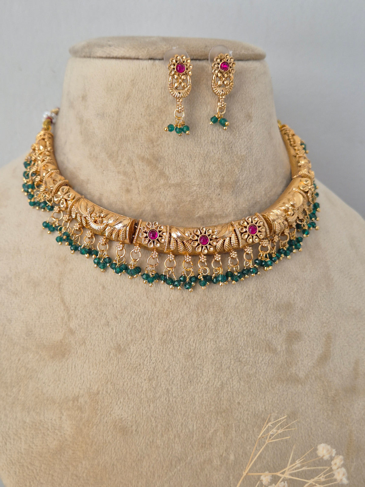 Handcrafted brass alloy traditional Indian necklace set with intricate deity carvings and stone embellishments by Naitri.in